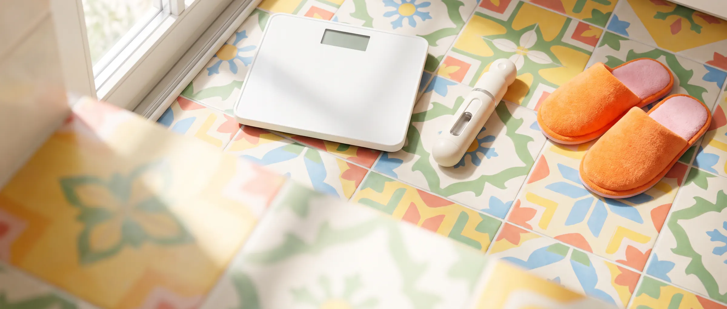 A bathroom scale on a colourful tiled floor with a plain injection pen beside it
